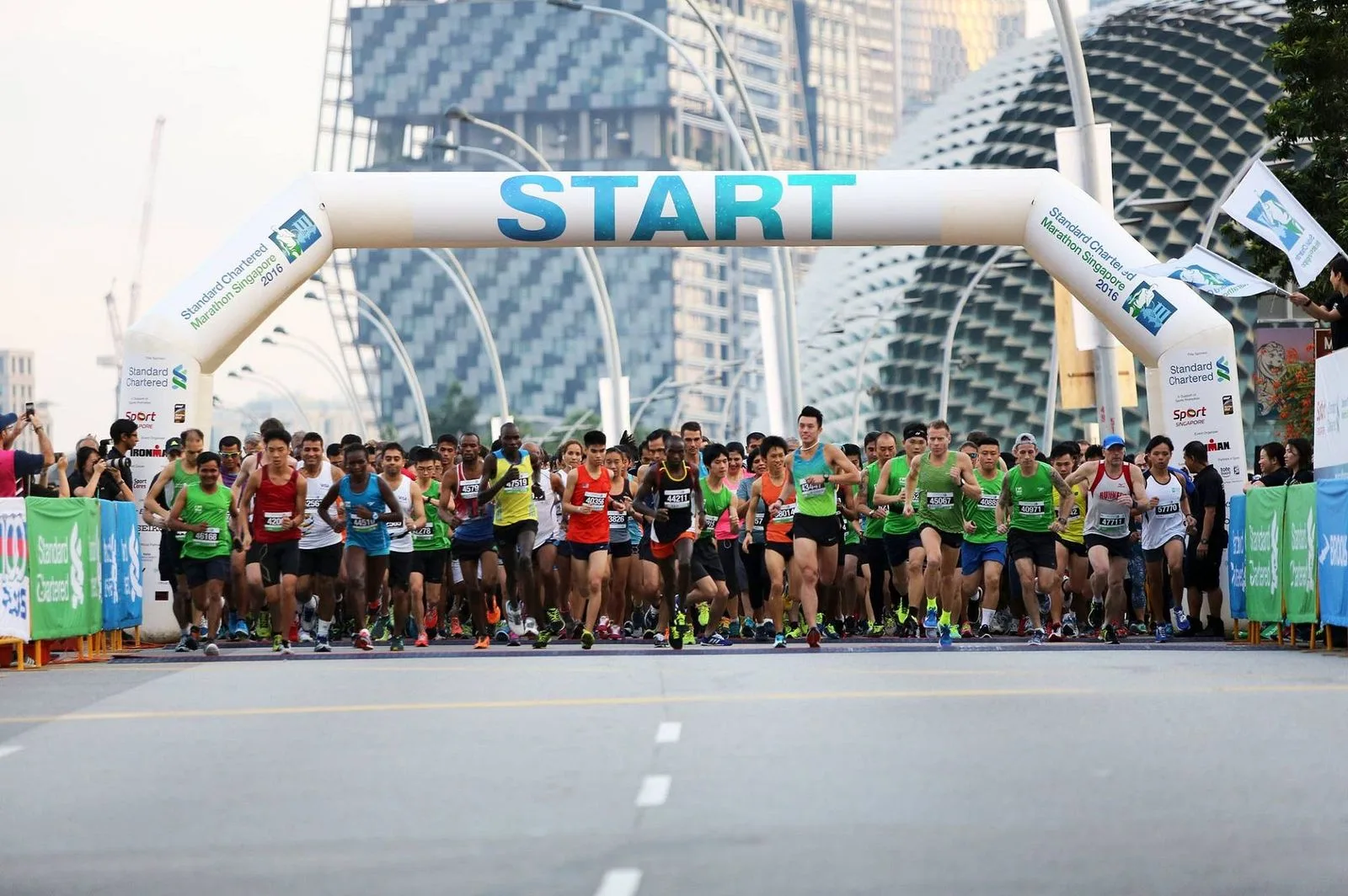 Runners setting off under the start arch of the Standard Chartered Singapore Marathon