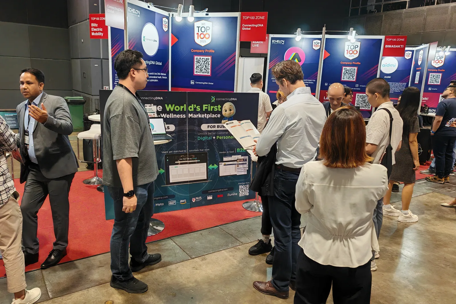 Visitors gathered at the ConnectingDNA booth at a trade show, its backdrop reading The World's First DNA-Wellness Marketplace