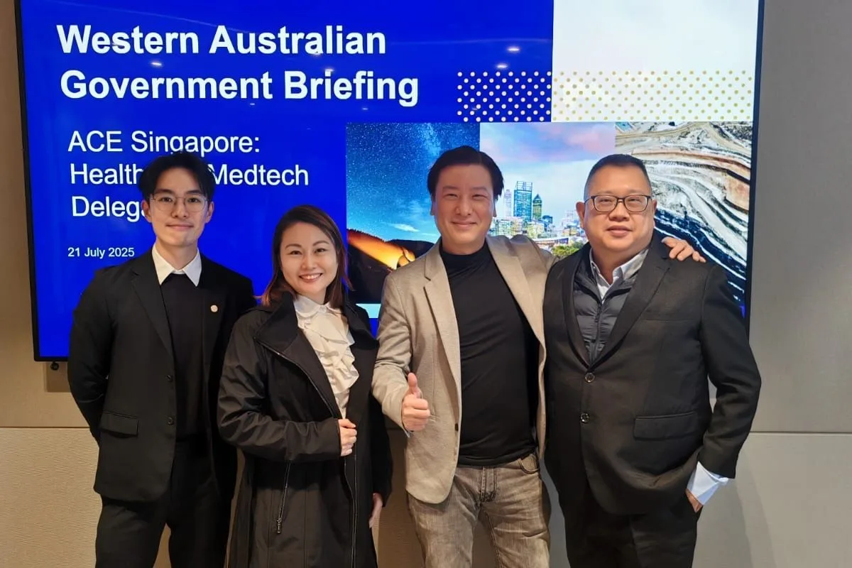 Four people standing before a screen reading Western Australian Government Briefing, ACE Singapore: Health and Medtech Delegation, 21 July 2025