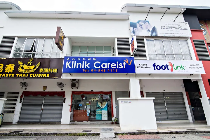 The Klinik Careist shopfront in a Malaysian shophouse row, shutters down